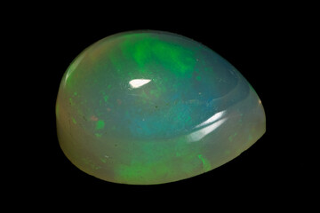 Wall Mural - natural rainbow opal gem isolated on black background