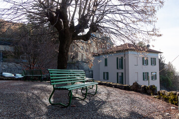 An empty bench in a small park in Brunate, on a mountain above Lake Como