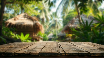 Aufkleber - A wooden tabletop sits in the foreground, with a blurred background of lush tropical foliage and thatched-roof huts.