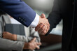 © Yingyaipumi - Businessman handshake for teamwork of business merger and acquisition,successful negotiate,hand shake,two businessman shake hand with partner to celebration partnership and business deal concept