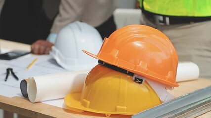 Wall Mural - Teamwork men in construction site, Two civil engineer or professional foreman in safety helmet hard hat using blueprint in digital tablet working while standing at industrial factory, teamwork concept