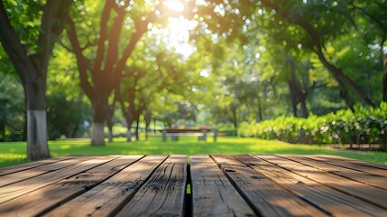 The background of the park garden with the blurred green tree and empty wood table top can be utilized to showcase or montage your products.