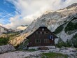 © Semi - Ceska Koca mountain hut on the way to Grintovec Mountain in Julian Alps, Slovenia. A picturesque rest stop for hikers amidst breathtaking alpine scenery.
