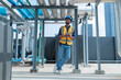 © Washburn - Engineer Inspecting Industrial Pipes on Rooftop