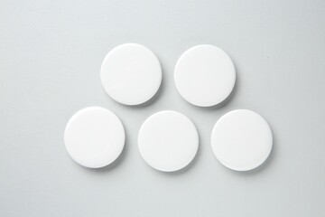 Sticker - Blank white button badges on light background, flat lay. Mockup for design