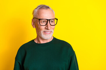 Wall Mural - Photo portrait of nice senior man look empty space dressed stylish green clothes isolated on yellow color background