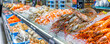 © Volodymyr - A grocery store with a selection of fresh seafood, including fish, shrimp, and lobster.
