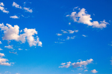 Wall Mural - white fluffy clouds on the blue sky in summer. bright sunny weather forecast
