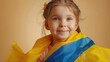 © Akmalism - Happy little girl with Ukrainian flag on beige background.