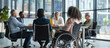 © Eomer2010 - Meeting around a table in the office of a multiethnic and inclusion team, with a person in a wheelchair. Concept of diversity