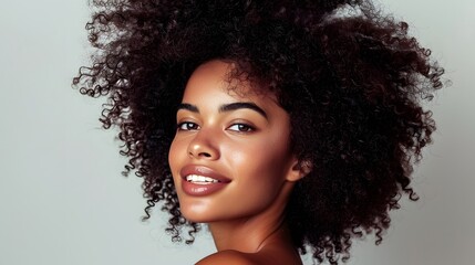 Wall Mural - Woman with Natural Hair: A woman with natural, curly hair styled beautifully, with a simple background to highlight her features.
