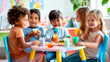 © Kateryna - a cheerful group of preschool kids sitting together at a small table, enjoying healthy snacks and chatting during their break, perfect for themes of nutrition, social interaction,