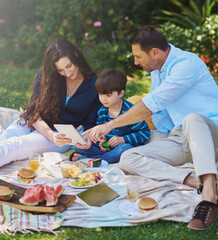 Poster - Kid, picnic and parents on tablet at park, eating lunch and family bonding together in summer. Mother, child and dad on technology outdoor for learning, streaming and watch movie to relax with food