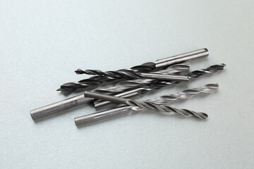 Wall Mural - Many different drill bits on light grey background, above view