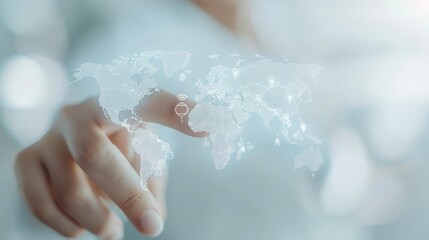Wall Mural - A hand is pointing at a globe with a white background