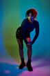 © LIGHTFIELD STUDIOS - African American woman poses confidently in a short skirt and boots.