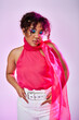 © LIGHTFIELD STUDIOS - A beautiful African American woman poses actively in white pants and pink top.