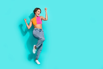 Sticker - Full length photo of lucky impressed woman wear pink orange top yelling yeah rising fists empty space isolated teal color background