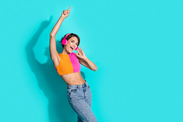 Sticker - Photo of funky cheerful lady dressed colorful top dancing listening songs earphones empty space isolated turquoise color background