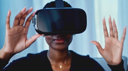 Poster - A woman wearing a VR headset looks ahead with a slight smile. She sits indoors in front of a window, with her hands outstretched in front of her.