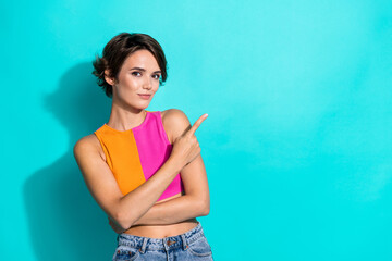 Canvas Print - Photo of pretty cute woman wear pink orange top showing finger empty space isolated teal color background