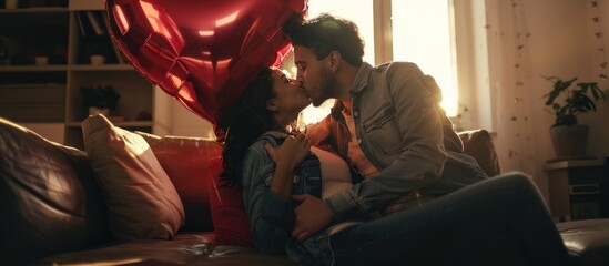 Young couple in love holding a heart-shaped balloon while sitting