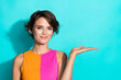 © deagreez - Photo of sweet charming lady dressed colorful top holding arm empty space isolated turquoise color background