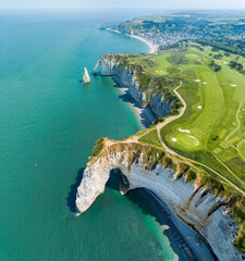 Wall Mural - Aerial view of Etretat cliffs and the Atlantic ocean. Chalk cliffs and three natural arches. Panoramic path to admire the coast. Normandy region of Northwestern France. 06-26-2024