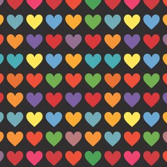 Seamless pattern of rainbow colored hearts on a black background