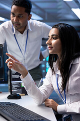Poster - coworkers in high tech data center checking equipment performance on computer after upgrading infras