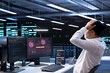 © DC Studio - Technician in server hub doing face palm gesture, trying to protect hardware from hacker stealing information. Close up of data center employee stressed by security breach alert caused by virus