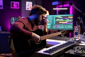 Leinwandbilder - Tired overworked musician playing acoustic guitar in his home studio, recording new songs for music industry production. Stressed artist dealing with burnout after audio session, control panel.