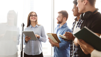 Aufkleber - A diverse group of multiracial young people standing in front of a whiteboard, engaged in a discussion or presentation. Some are pointing at the board while others are taking notes