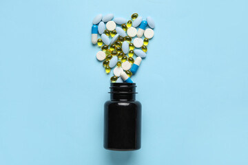 Wall Mural - Bottle with pills on blue background