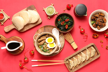 Wall Mural - Composition with delicious Chinese dishes and decor on red background