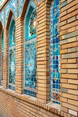 Poster - A brick building with vibrant stained glass windows, perfect for use in architectural or interior design contexts