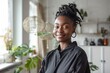 © Baba Images - Smiling portrait of a young female African American interior designer