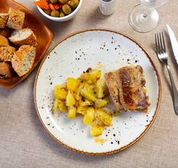 Sticker - Service plate containing stewed pork and pieces of potato with necessary table laying