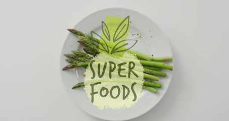 Poster - Super foods text image over plate of fresh asparagus