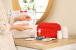 © Pixel-Shot - Woman taking drops from first aid kit in bathroom, closeup