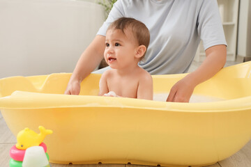 Sticker - Adorable little baby with mother bathing at home