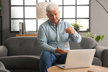 Wall Mural - Male hypnotist with pocket watch working online in office