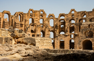 Wall Mural - Half-destroyed ancient Roman amphitheater in northern part of Africa, legacy of Roman colonization. Historical landmark is located in city of El Jem, Tunisia