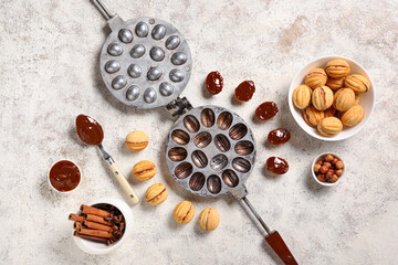 Wall Mural - Tasty walnut shaped cookies with boiled condensed milk and baking form on white grunge table