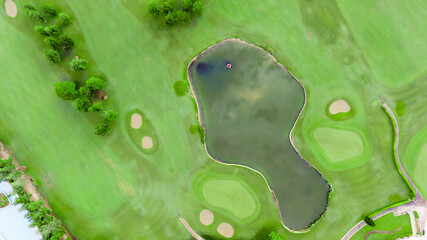 Wall Mural - Top view of golf course with pond and bunkers. Scenic panoramic view of golf fairway