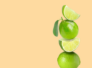 Wall Mural - Stacked fresh limes on beige background, space for text