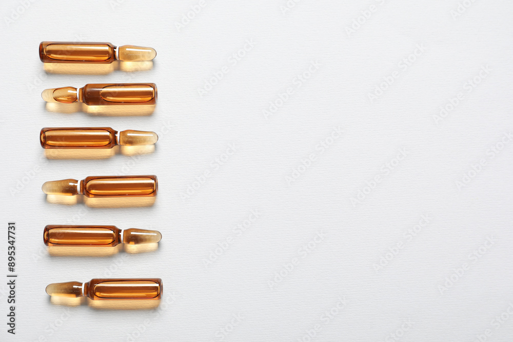 Glass ampules on grey background