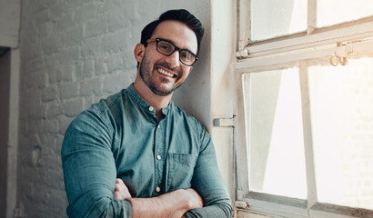 Poster - Business man, glasses and happy portrait for creative startup, confidence and arms crossed by window. Entrepreneur, eyewear and face smile with pride for marketing agency, manager and relax in office