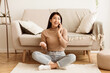 © Prostock-studio - Teenage Girl Talking on Phone, Communicating with Friend, Sitting on Floor near Sofa
