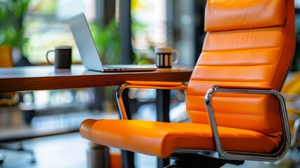 Poster - A modern office workspace featuring a comfortable orange leather chair, a laptop, and a wooden desk. The chair represents productivity, the laptop symbolizes technology, the desk signifies professiona